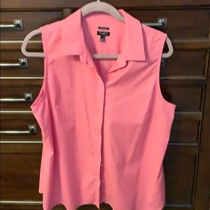 Sleeveless button up blouse.